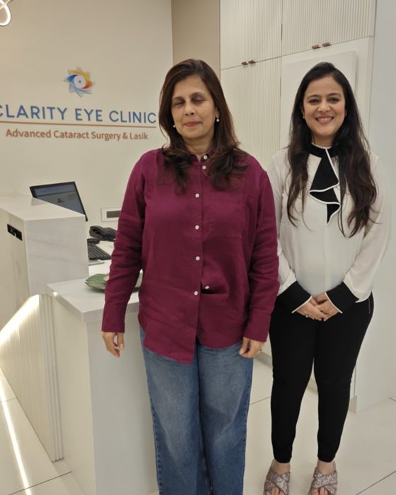 A patient with a member of the Clarity Eye Clinic team at the clinic reception